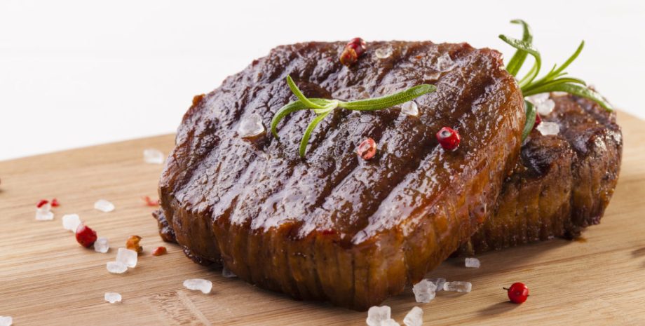 Grilled beef steak on wooden board