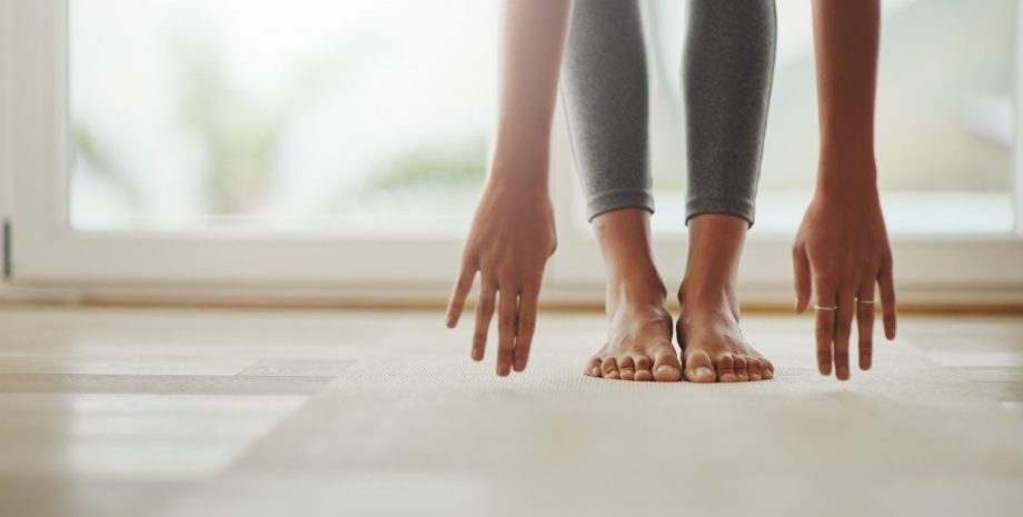 Cropped shot of a young woman practicing yoga at home
