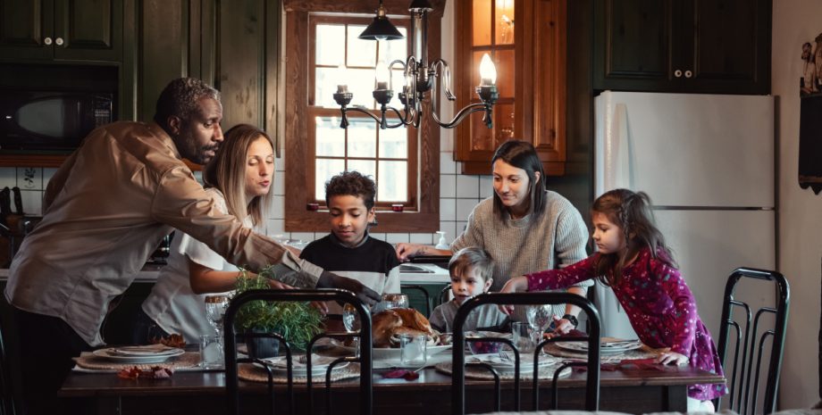 A family of four gathered around the dining table.
