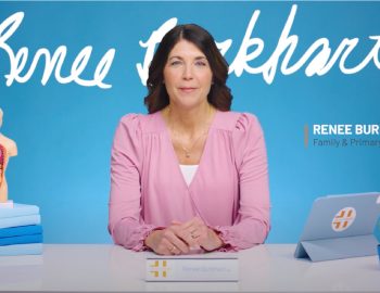 A photo of Renee Burkhart sitting at a desk.