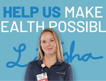 Nurse standing in front of a sign that says 