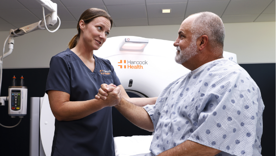 diagnostic radiology nurse holding hand of patient getting ready for a scan