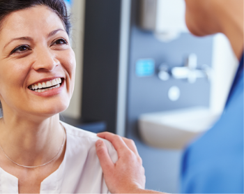 smiling patient talking to a nurse practitioner