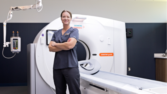 nurse practioner standing next to radiology machine