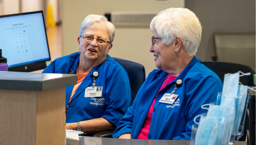 Older women volunteering at front desk